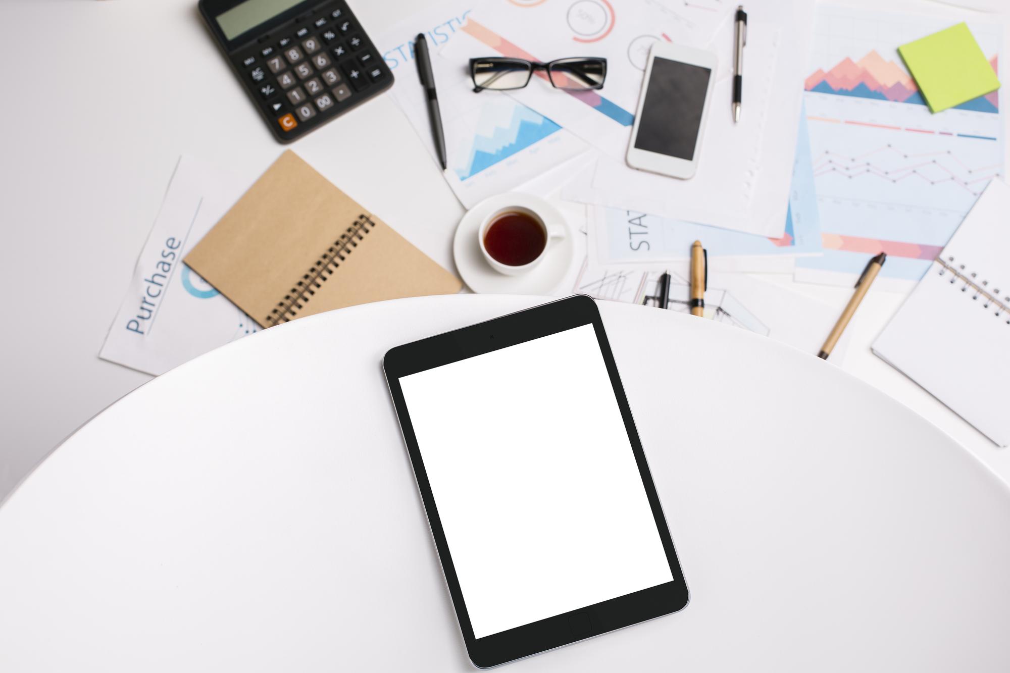 Flat lay with package materials and tablet